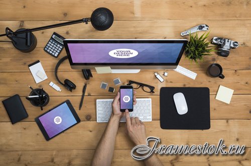 User with Desktop Computer, Tablet, and Smartphone on a Cluttered Wooden Table Mockup 2 124766571